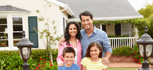 Smiling-Family-In-Front-Of-House-With-New-Roof